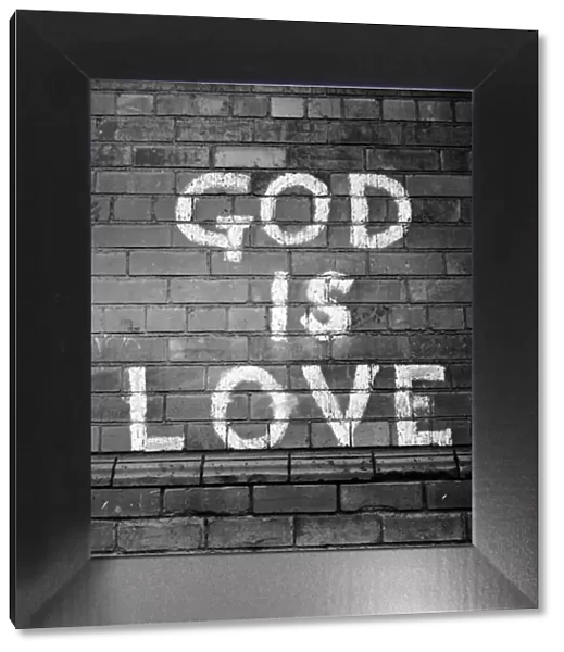Wall Sign. 20th February 1954: A painted sign on a wall in Belfast reading God Is Love