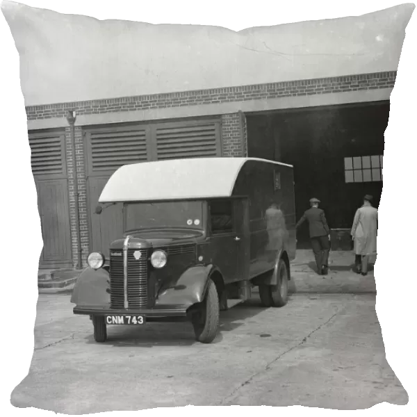 Men carrying the totalisators from a Bedford truck at Hurst Park Racecourse in Molesey