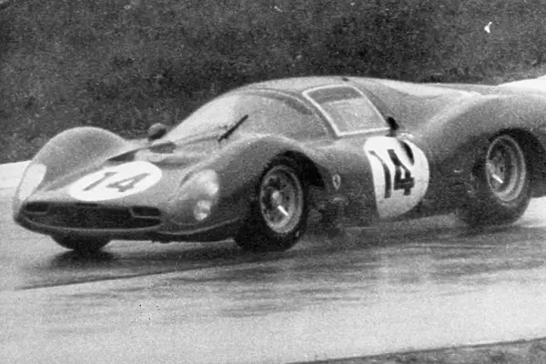 John Surtees pictured in action in heavy rain at the 1000 km Monza International race