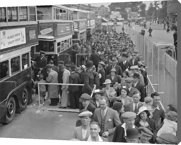 The Epsom Derby Summer Race Meeting. Derby Day crowds boarding buses at Morden