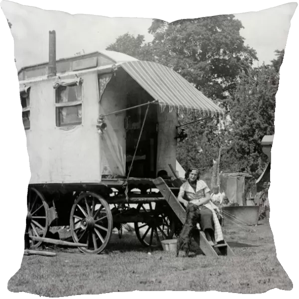A gypsy woman sitting on the steps to her Romany caravan in the gypsy camp on Epsom Downs