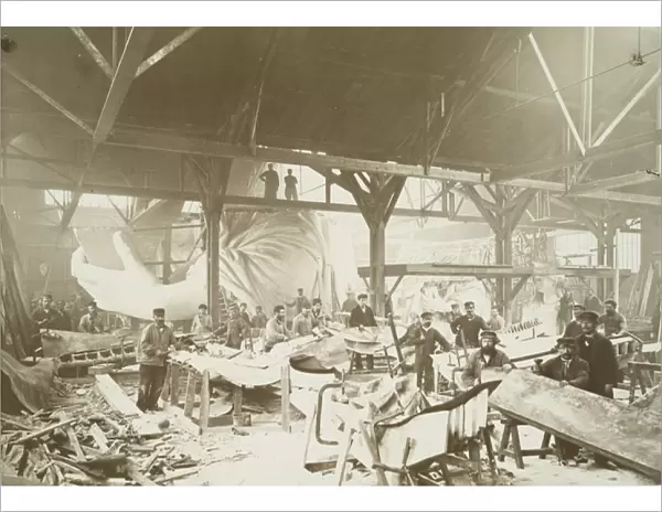 Men in a workshop hammering sheets of copper for the construction of the Statue of