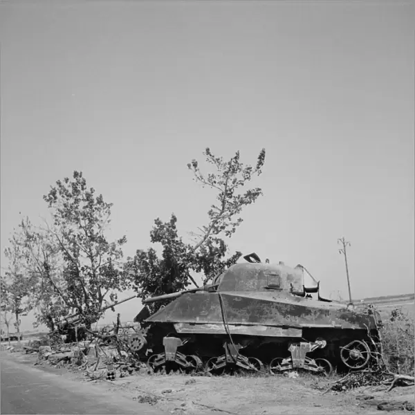 Wreckage of a General Sherman tank and a German 88mm gun, Sicily, 1943