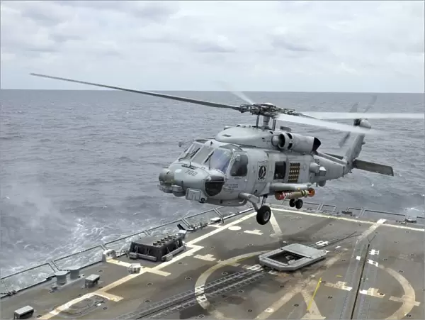 An MH-60R Sea Hawk helicopter lifts off from USS Wayne E. Meyer