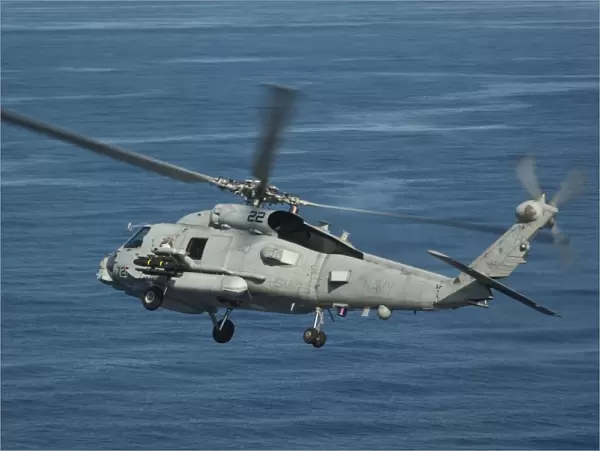 An MH-60R Sea Hawk maneuvers over the South China Sea