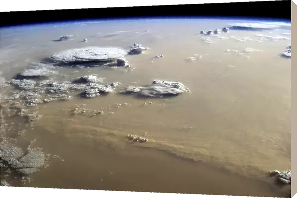 View of a dust storm that stretches across the sand seas of the Sahara Desert