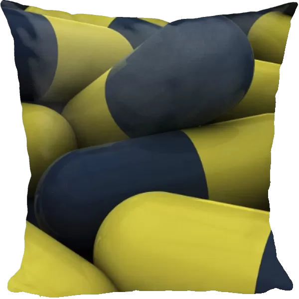 Pile of blue and yellow medication capsules