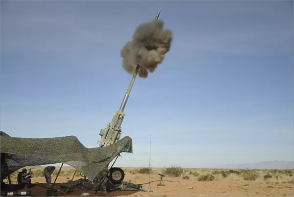 The M982 Excalibur 155mm round leaves the barrel of an M777 Howitzer
