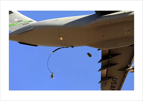 U.s Air Force Airmen parachute into a drop zone from a C-17 Globemaster III