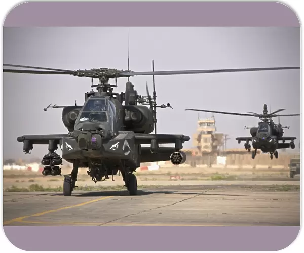 Two AH-64 Apache helicopters return from a mission over Iraq