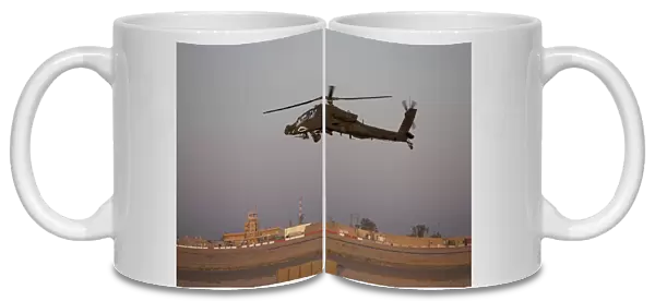An AH-64D Apache Longbow Block III flies by the control tower on Camp Speicher