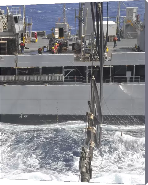 A fuel probe is connected from USNS John Lenthall to USS Bataan