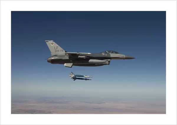 An F-16 Fighting Falcon releases two GBU-12 laser guided bombs