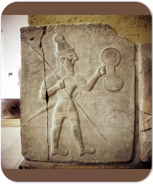 Hittite relef of a Hittite warrior or war-god with shield spear and sword
