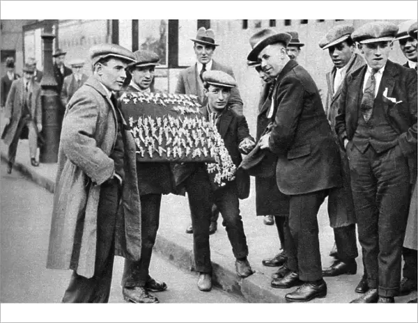 Street hawker selling football favours in Kings Cross, London, 1911 (1926-1927)