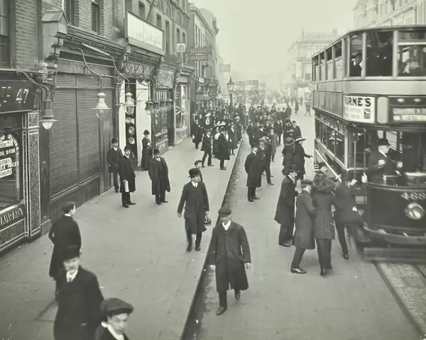 People rushing to get on a trolley bus at 7. 05 am, Tooting Broadway, London, April 1912
