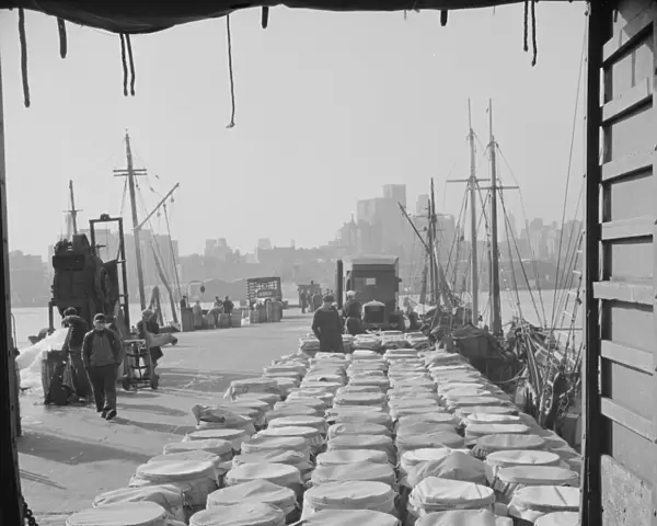 Barrels of fish on the docks at Fulton fish market ready to be shipped to... New York, 1943. Creator: Gordon Parks