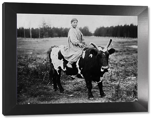 A girl riding a bull, 1890. Creator: Unknown
