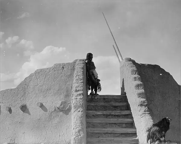 Tewa Indian guard at top of the kiva stairs, San Ildefonso, New Mexico, c1905. Creator: Edward Sheriff Curtis