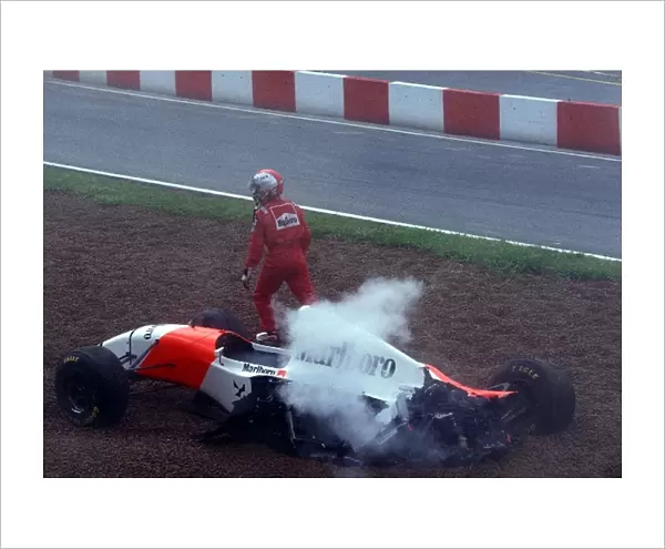 Formula One World Championship: Michael Andretti gets out of his McLaren Ford MP4  /  8 after being involved in a first corner accident