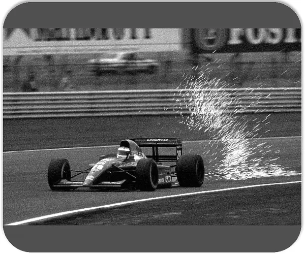 Formula One World Championship: The sparks fly from the back of the Ferrari of Jean Alesi