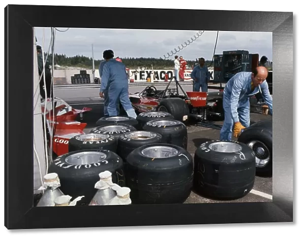 1976 Swedish Grand Prix: Ferrari 312 T2 cars in the paddock with their Goodyear tyres being changed, portrait