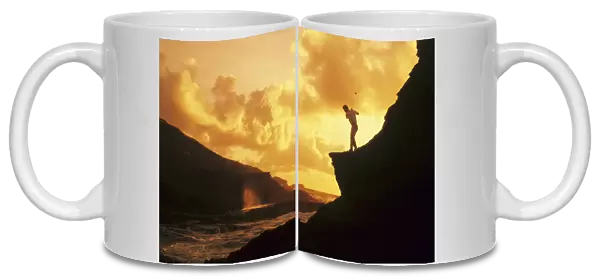 Hawaii, Golfer Standing On A Cliff And Swinging A Golf Club
