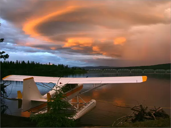 Sunlit Storm Clouds Over A Float Plane With Rainbow And Teslin Bridge In Background, Teslin Lake, Yukon