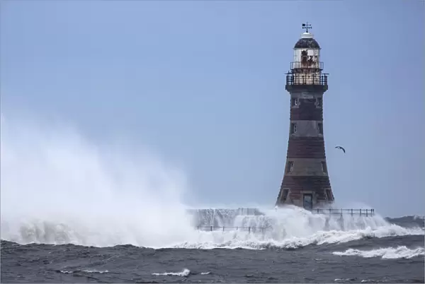 Splashing water from a crashing wave against a lighthouse; Sunderland Tyne and Wear England