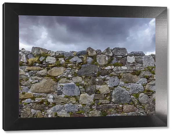 Close-up of a stone wall of an abandoned church with storm clouds on the Isle of Skye in Scotland, United Kingdom