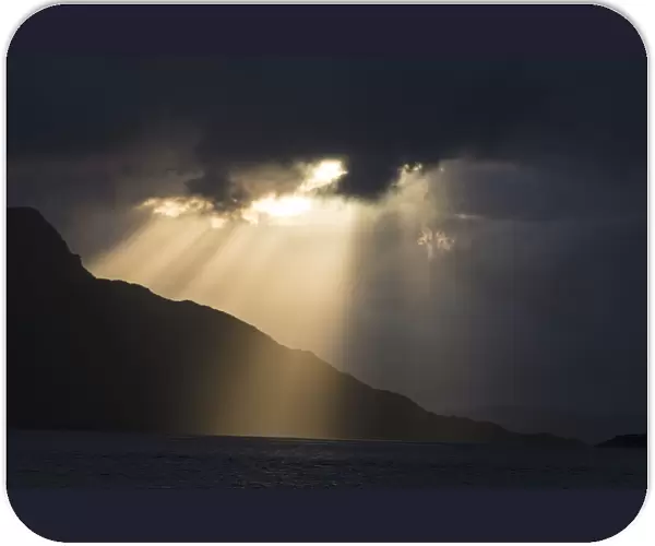 Atlantic Ocean and silhouette of the coastal mountains at sunset near Kylesmorar; Mallaig, Scotland