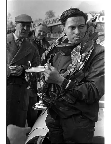 Jim Clark motor racing champion with trophy in 1963