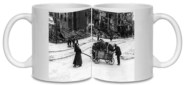 An old woman and her husband trundle through the Leipzig Strasse of Berlin