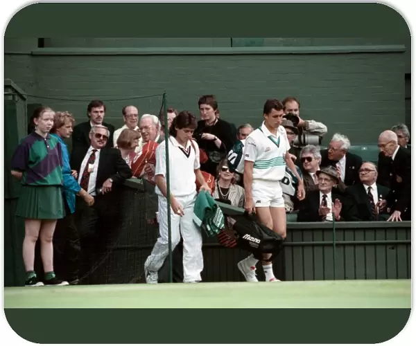 Wimbledon Tennis Championships. Ivan Lendl and Kelly Evernden walk out on court