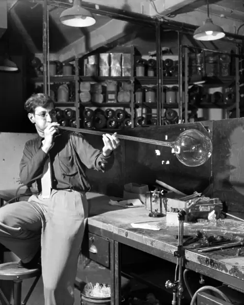 Glass blower Man blowing glass in his workshop. October 1952 C4910