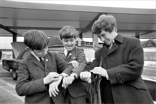 Three children check their watches against local US time on arrival in New York