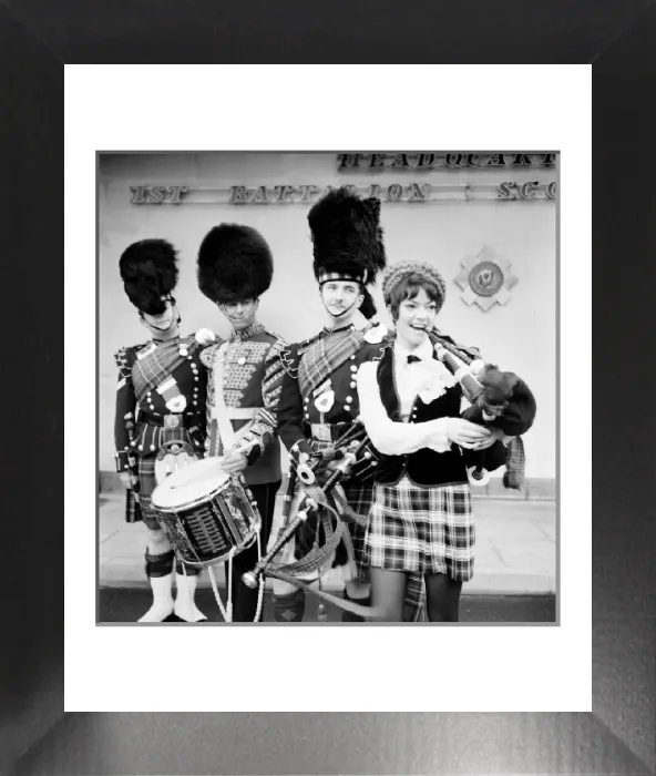 Framed Print : Black and white print of a young woman attempting to play the bagpipes