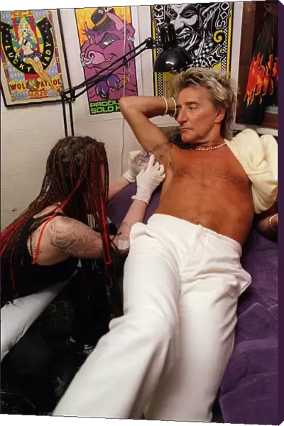 Rod Stewart 21st June 1999 as tattoo artsit Ronda Hoelzer decorates his arm with a