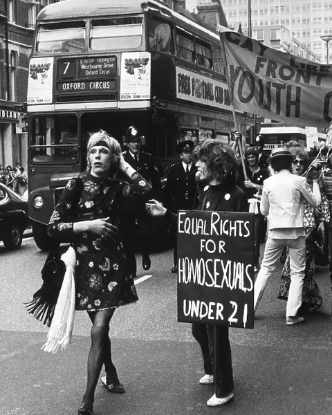 Gay Liberation March in Oxford Street Ginger a male walking past youth with placard