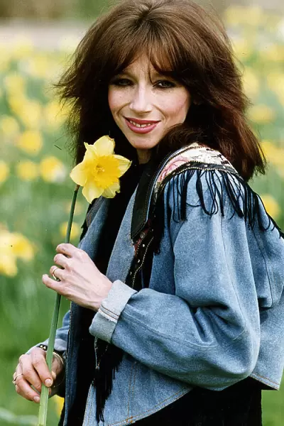Lena Zavaroni singer with daffodil flower outisde her house in London. April 1993