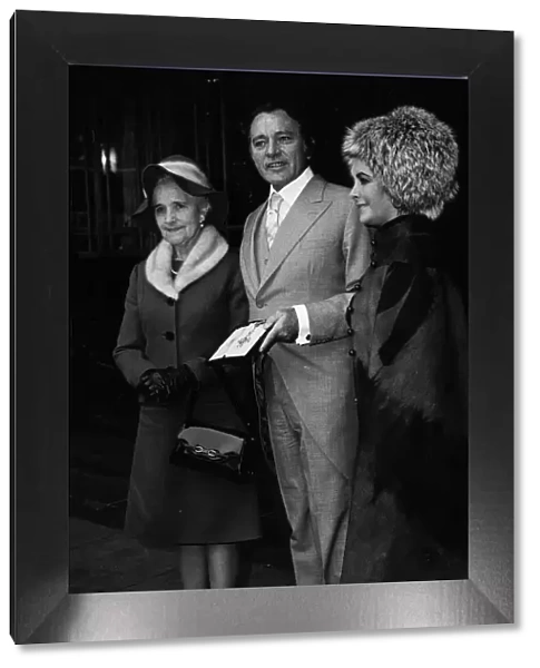 Richard Burton with his CBE insignia at the Palace in 1970 with Elizabeth