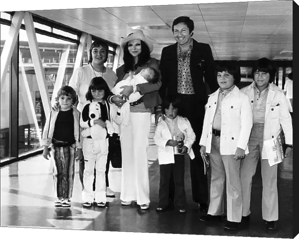 Joan Collins Actress with family at airport Dbase MSI