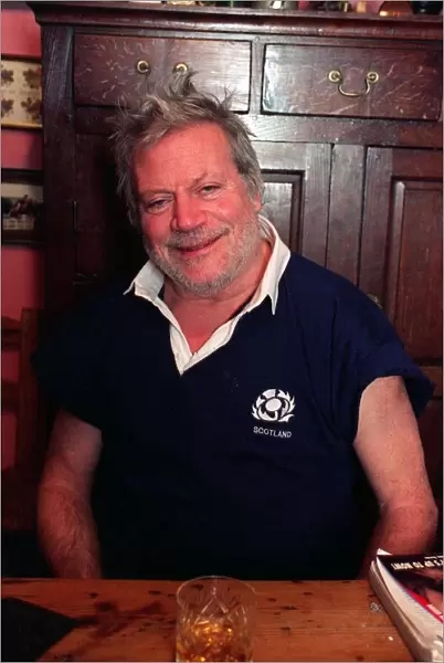 Oliver Reed actor wearing Scottish rugby shirt at home in County Cork Ireland