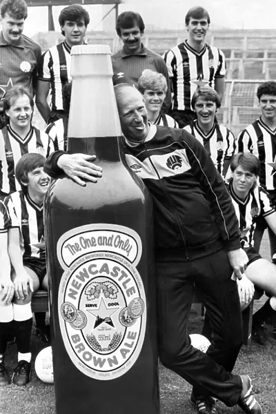 Newcastle United manager Jack Charlton clowns around with a giant bottle of Newcatle