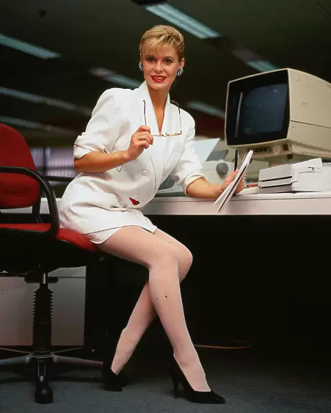 Model poses as secretary in Editorial wearing white suit