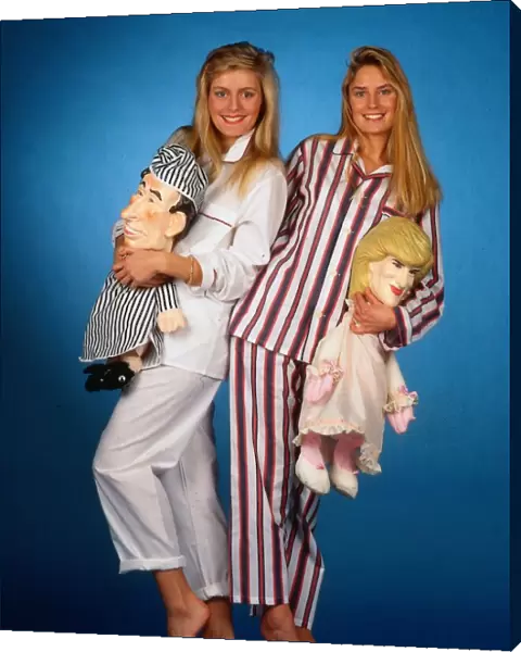 Models wearing mens pyjamas holding Princess Diana and Prince Charles pyjama cases