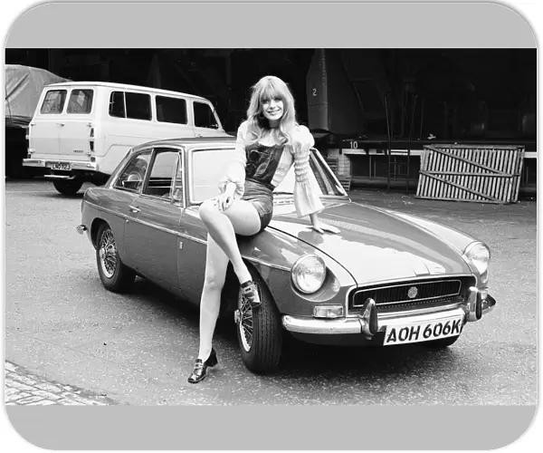 Reveille model Emma Vincent seen here posing with a MGB GT which is top prize in