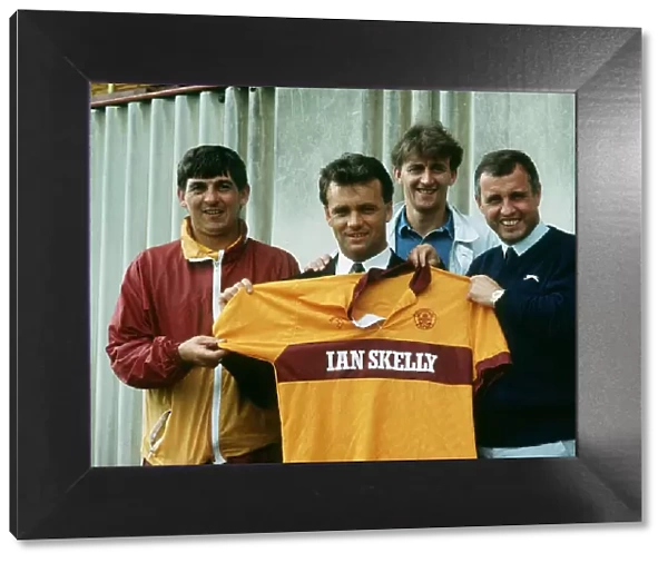 New Motherwell signing Davie Cooper poses with the team shirt as he stand with management