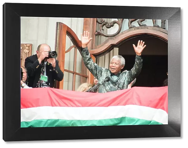 South African President Nelson Mandela waving to the crowds from the balcony of South