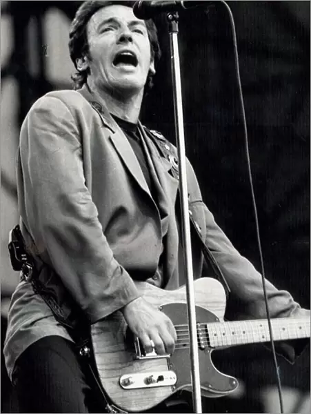 Bruce Springsteen performing on stage during a concert at Villa Park